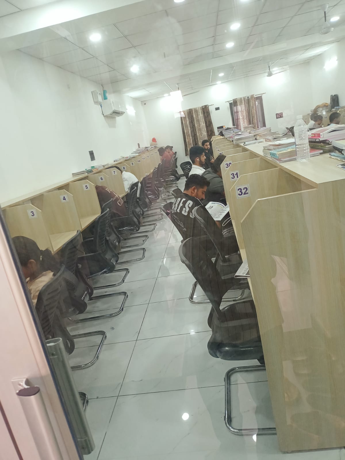 Study cubicles at Vidhyasthali Library with students studying